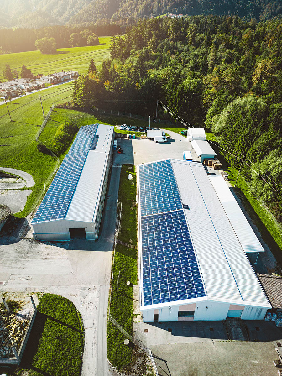 The sun is peeking through some commercial buidling shining on solar panels, use Solar Energy Partners for your commercial solar company today. 